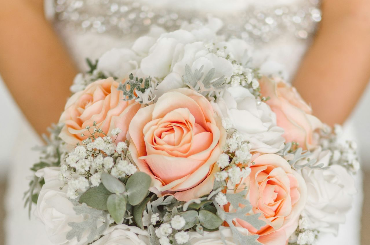 woman holding white and pink rose flower bouquet
